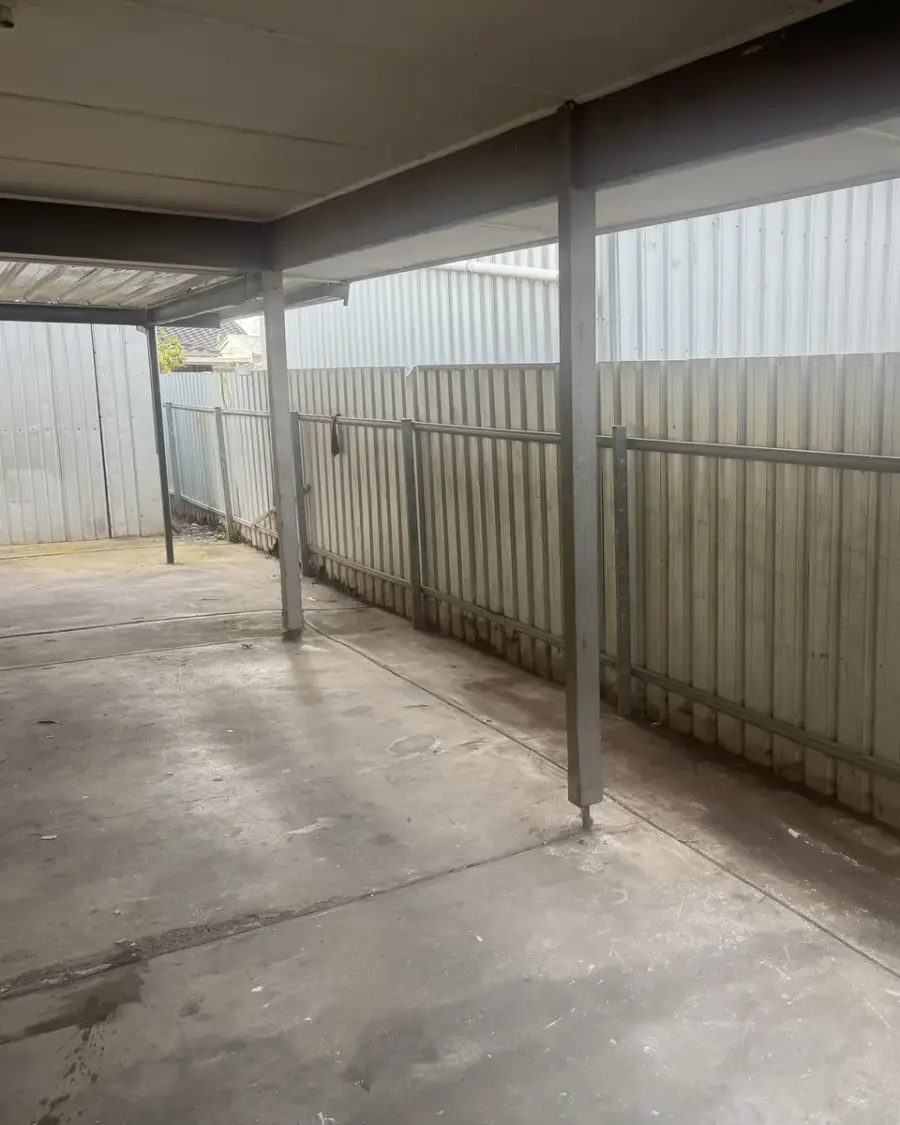After: Empty carport with a clear concrete floor