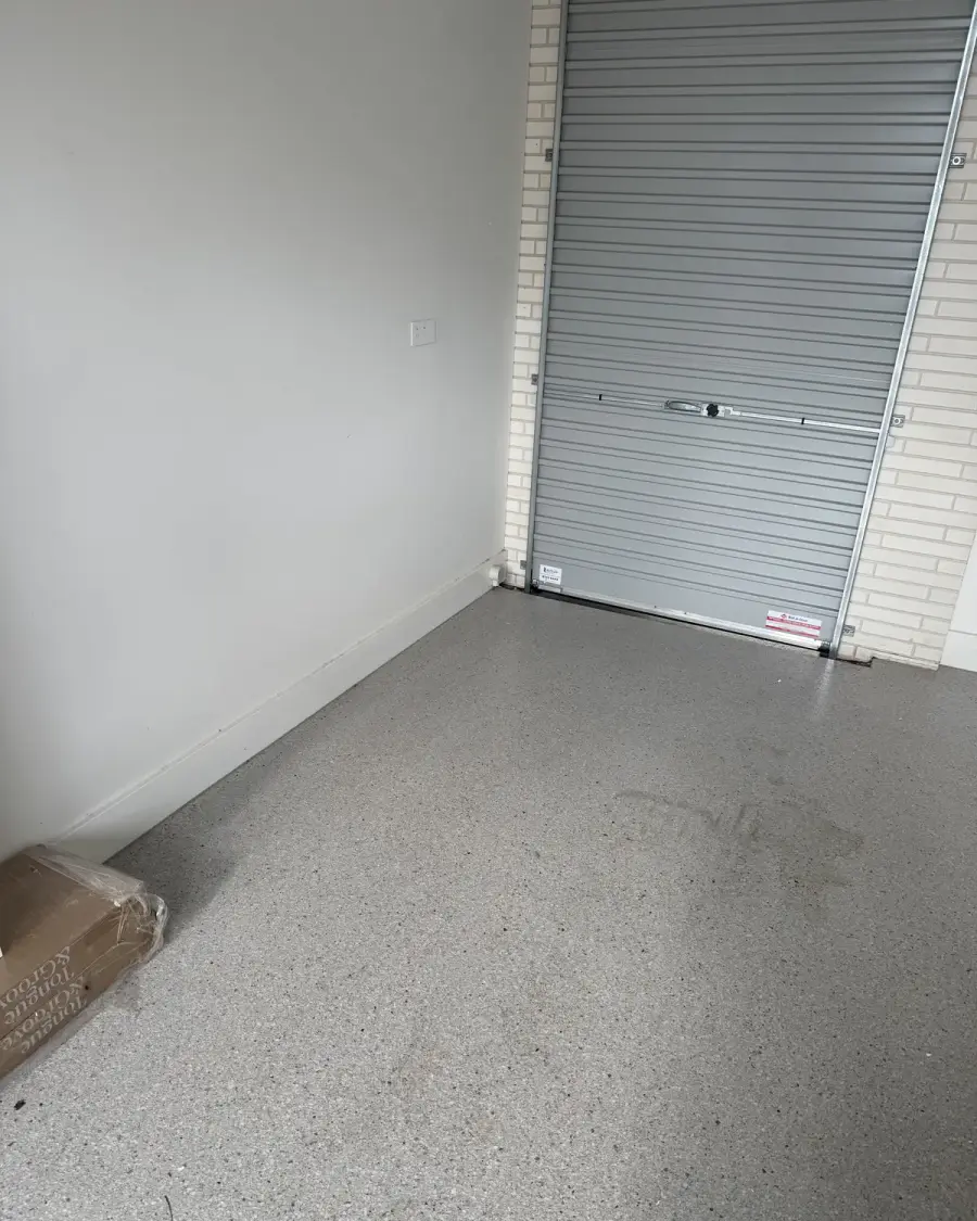After: Empty garage with a clear floor in front of the roller door