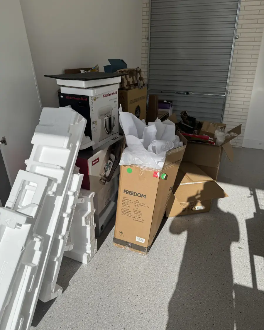 Before: Garage stacked with polystyrene, appliance boxes and packaging