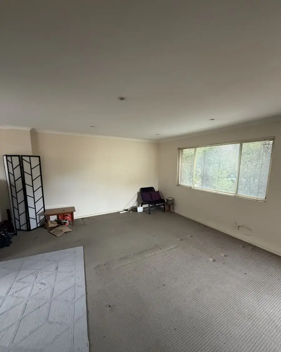 After: The same lounge room emptied of furniture