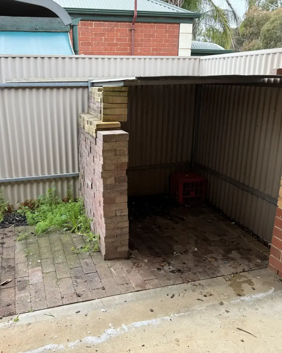 After: Empty brick and tin lean-to with the floor cleared