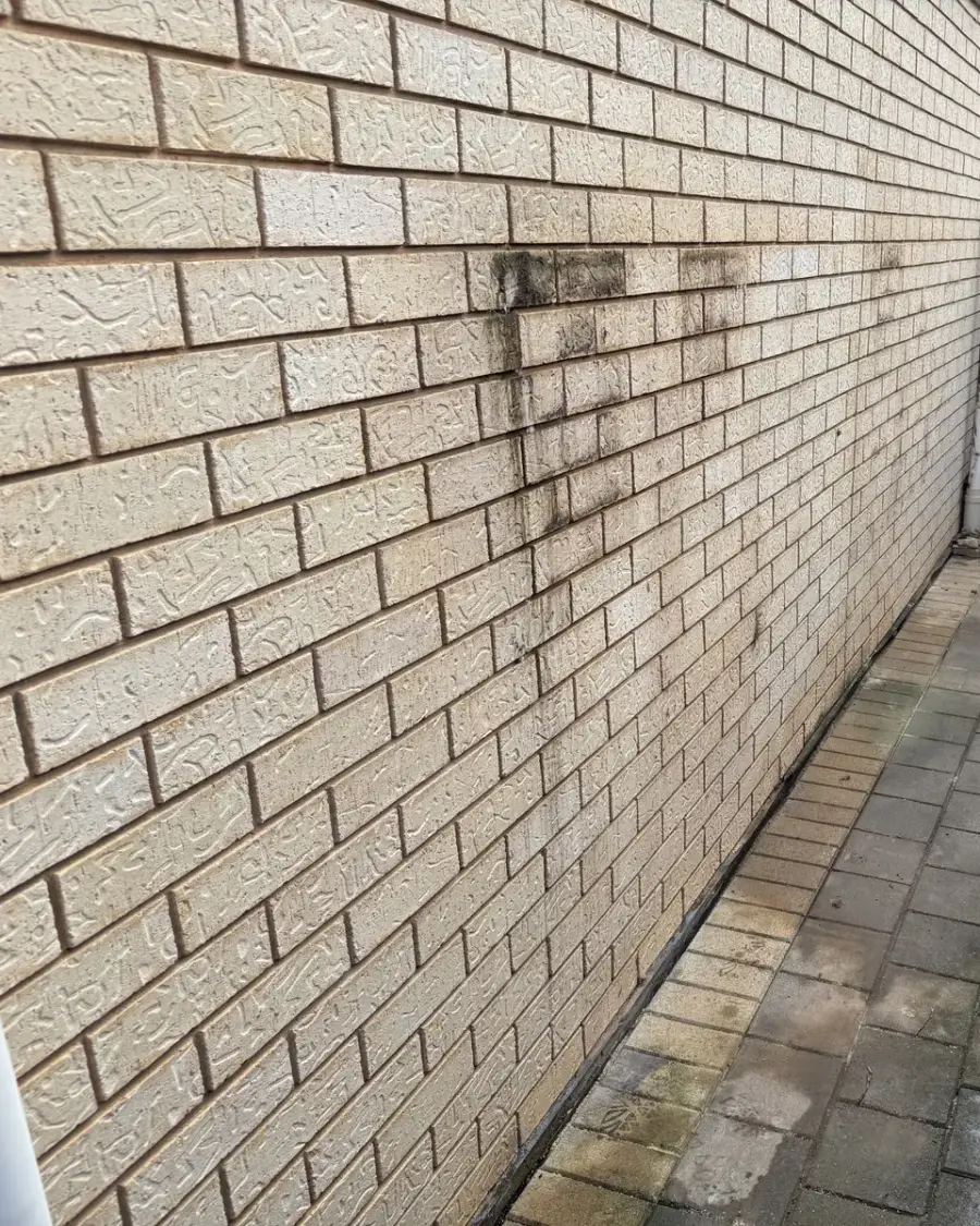 After: Brick wall and paved path with the water tanks removed